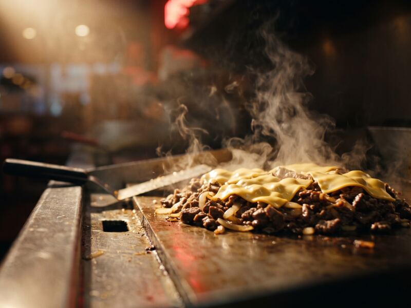 Chopped beef and melting cheese on the flat-top grill