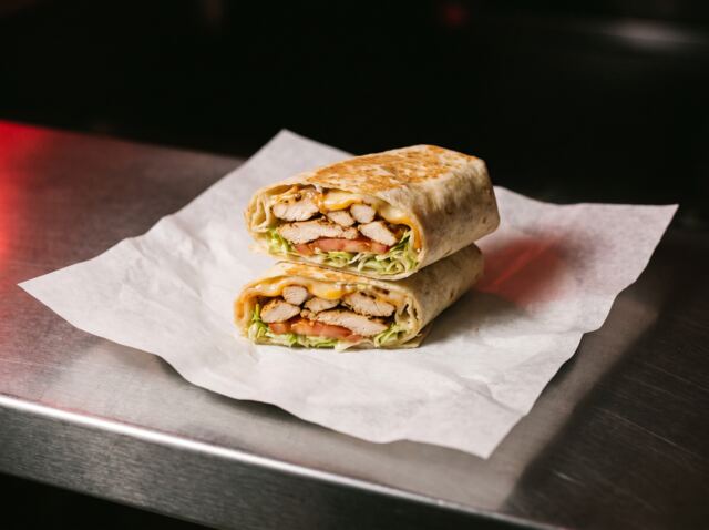 A deli wrap cut in half to show the filling